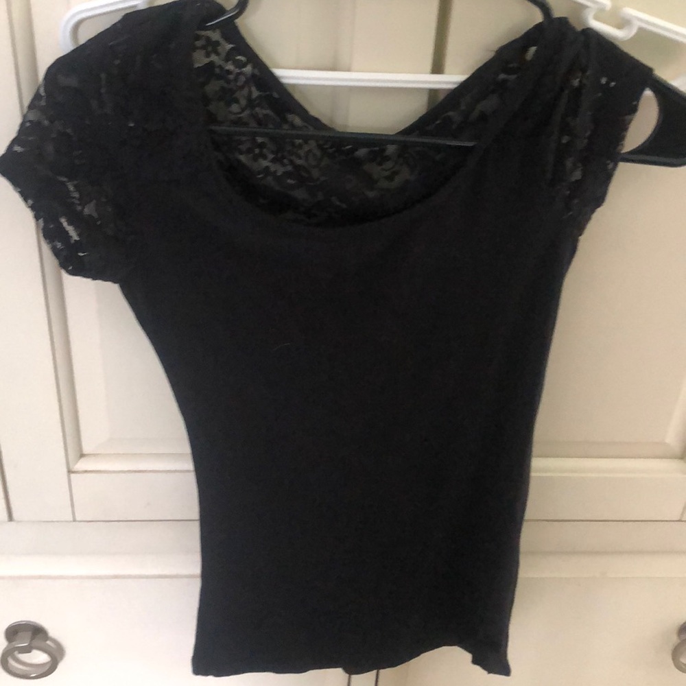 Ladies NWOT Small black shirt. Lacking detail.